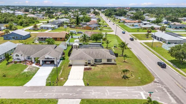 an aerial view of a residential houses with outdoor space