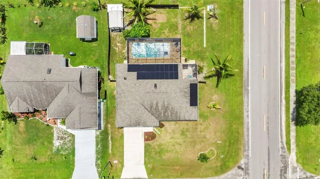 an aerial view of residential houses with outdoor space and street view