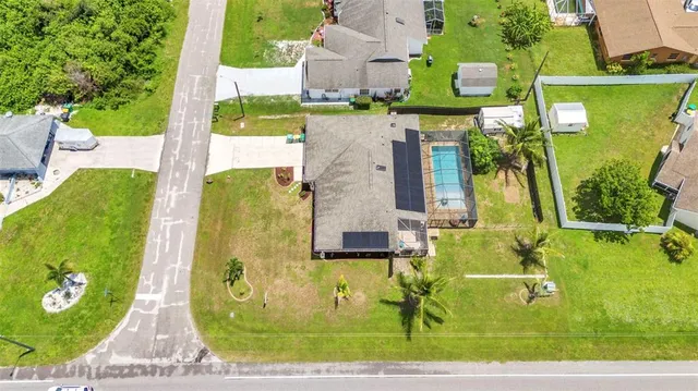 an aerial view of residential houses with outdoor space