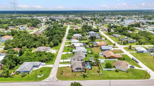 an aerial view of multiple houses with yard