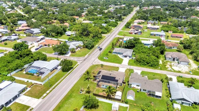 an aerial view of multiple houses with yard