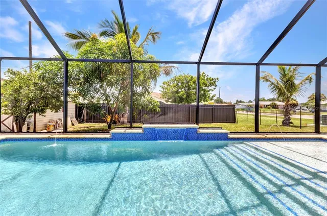 a view of a swimming pool with outdoor seating