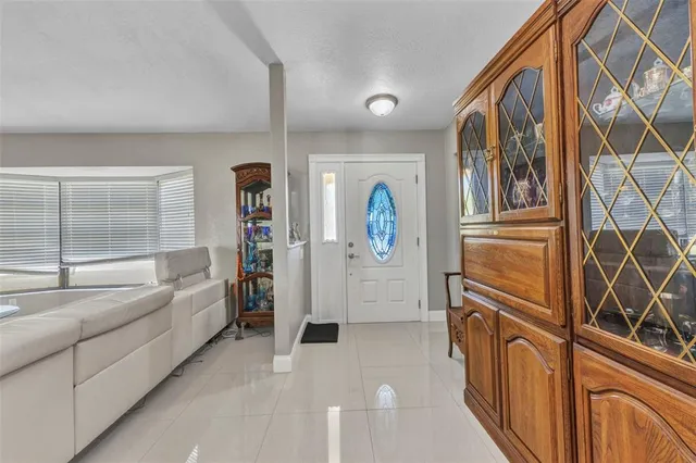 a living room with furniture a large window and a clock