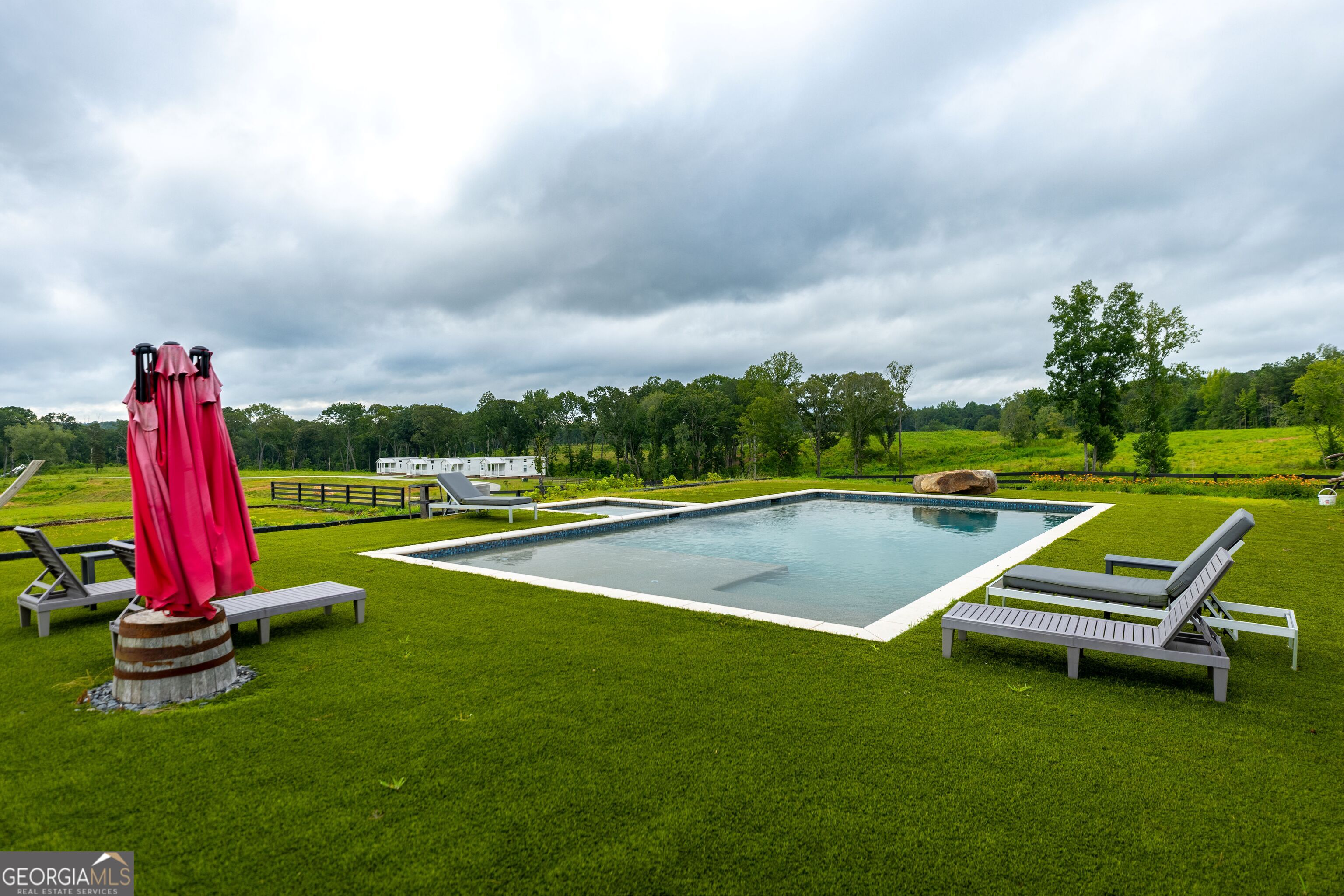 2199 Roosterville Road Roopville, GA 30170 - Photo 36 of 129 a view of a swimming pool with a yard and trees