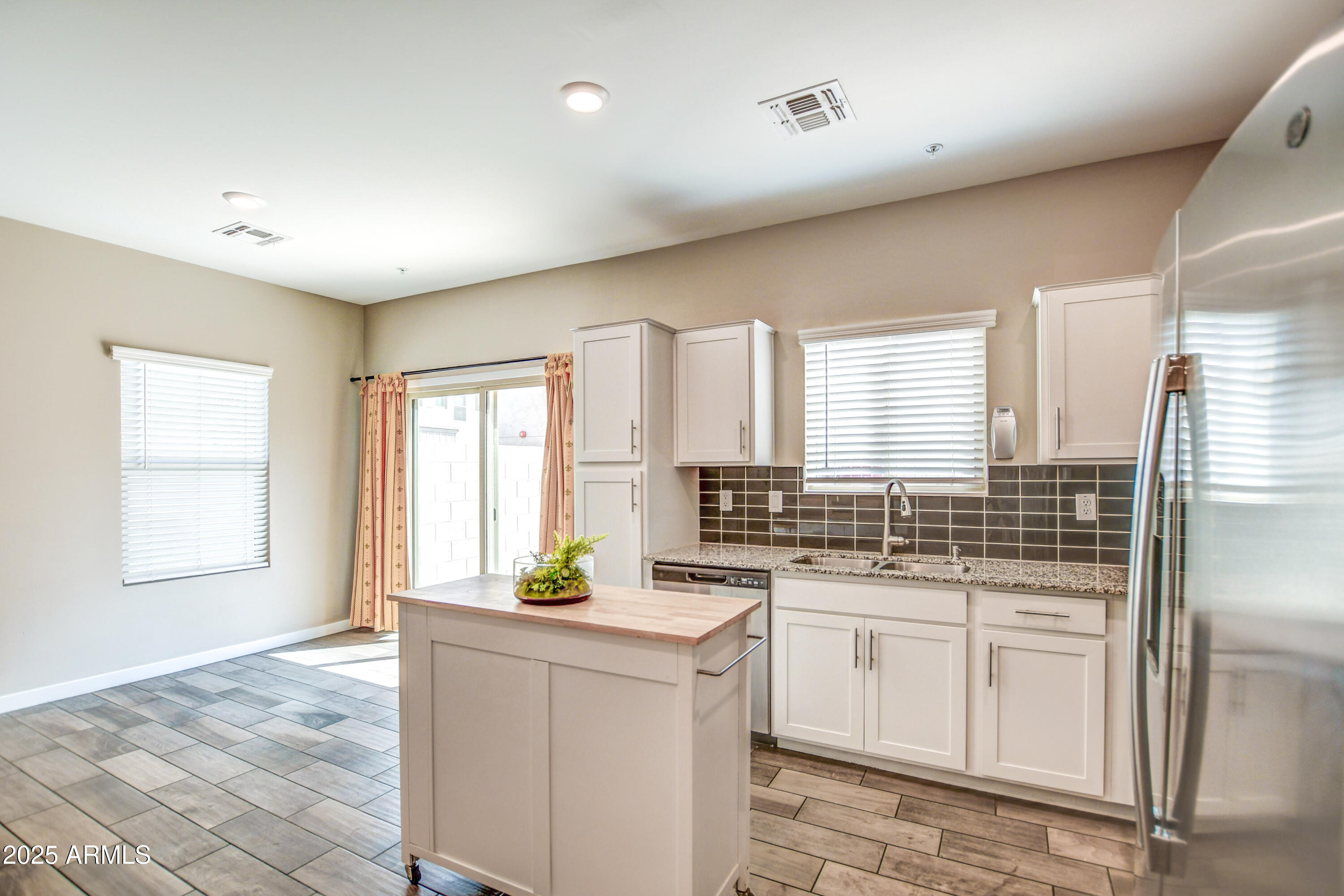 2241 West Griswold Road Phoenix, AZ 85021 - Photo 5 of 23 a kitchen with white cabinets and window
