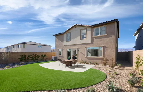 a view of a house with backyard porch and sitting area