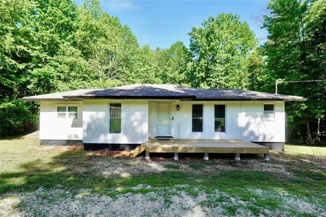 a view of house with backyard space and garden