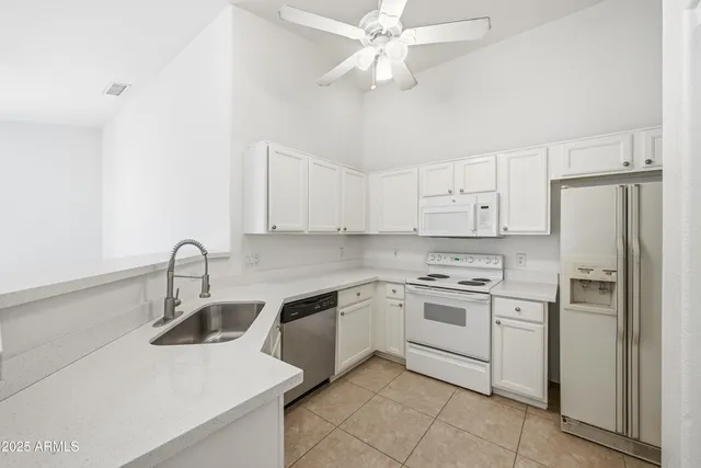 a kitchen with a sink appliances and cabinets