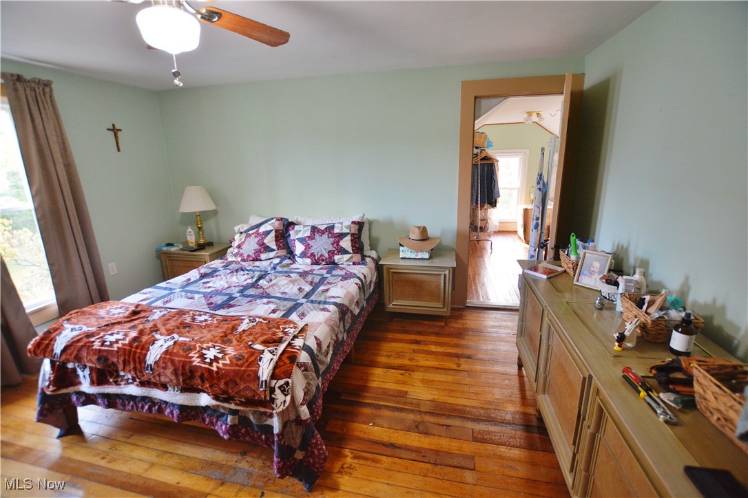 6696 Madison Road Thompson, OH 44086 - Photo 18 of 24 Bedroom featuring dark wood-type flooring and ceiling fan