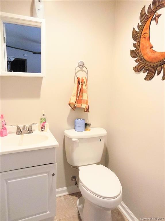 6925 Shelf Road Marshville, NC 28103 - Photo 22 of 24 a bathroom with a sink a toilet and a mirror