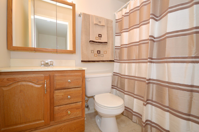 244 Inverrary Lane Deerfield, IL 60015 - Photo 11 of 17 a bathroom with a toilet sink and mirror