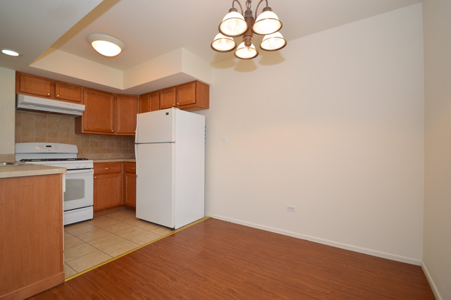 244 Inverrary Lane Deerfield, IL 60015 - Photo 4 of 17 a kitchen with a refrigerator and cabinets