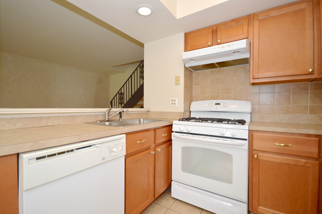 244 Inverrary Lane Deerfield, IL 60015 - Photo 6 of 17 a kitchen with a stove sink and a refrigerator