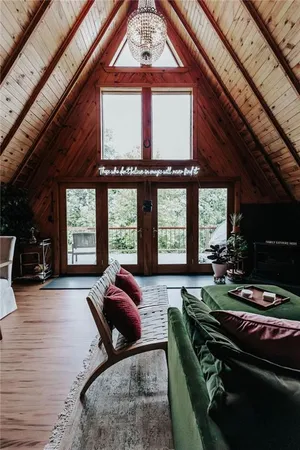 a living room with furniture and a floor to ceiling window