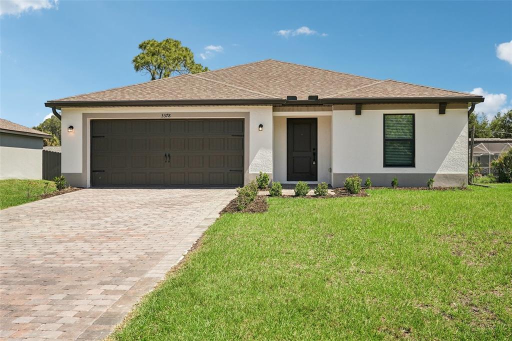 5237 Aberback Street North Port, FL 34291 - Photo 1 of 46 a front view of a house with a yard and garage