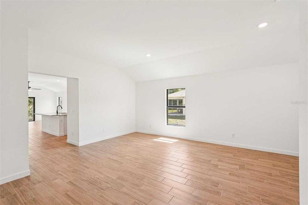 5237 Aberback Street North Port, FL 34291 - Photo 14 of 46 a view of a big room with wooden floor and a bathroom