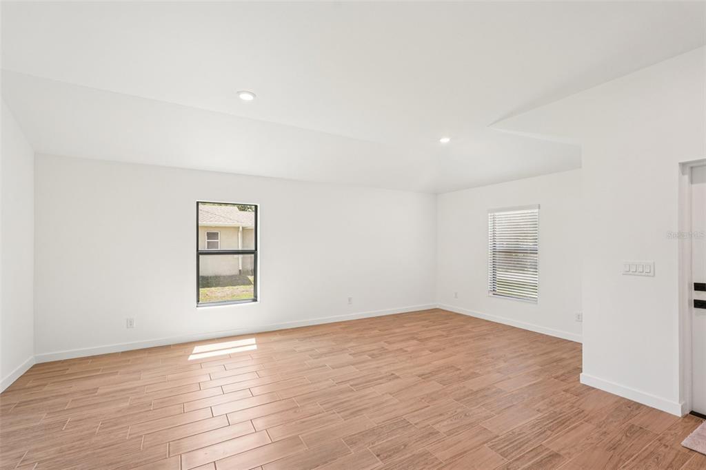 5237 Aberback Street North Port, FL 34291 - Photo 15 of 46 an empty room with wooden floor and windows