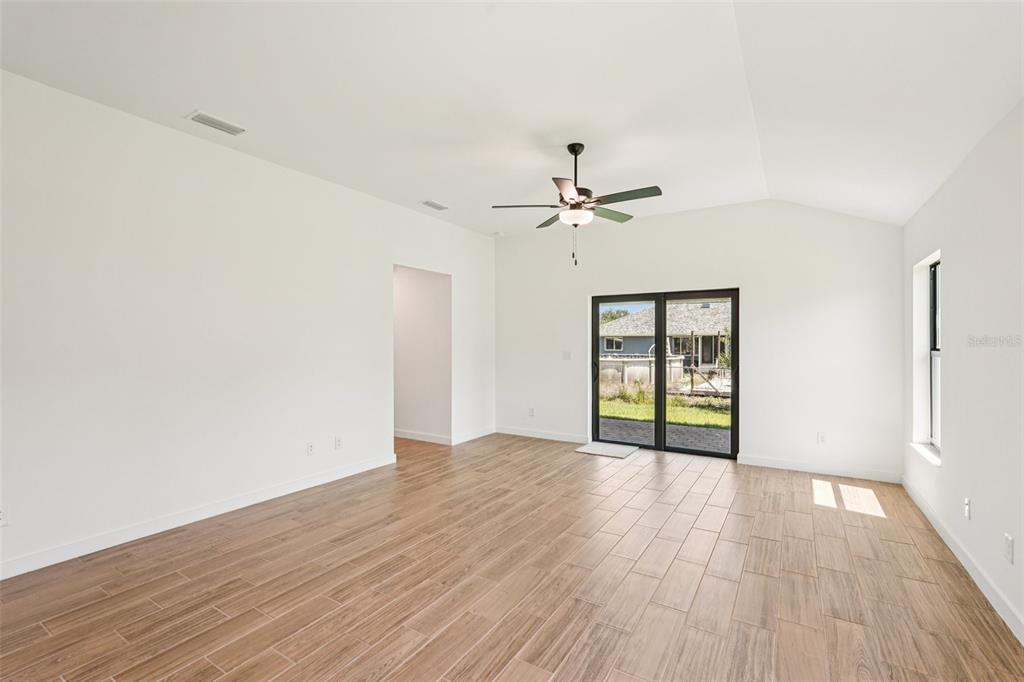 5237 Aberback Street North Port, FL 34291 - Photo 18 of 46 a view of an empty room with wooden floor and a window