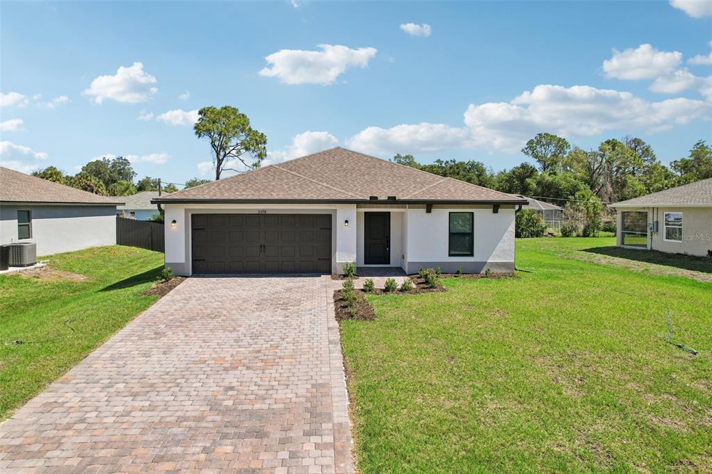 5237 Aberback Street North Port, FL 34291 - Photo 2 of 46 a front view of a house with garden