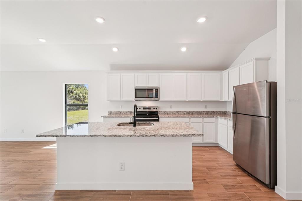 5237 Aberback Street North Port, FL 34291 - Photo 21 of 46 a kitchen with stainless steel appliances granite countertop a refrigerator a stove a microwave and a refrigerator