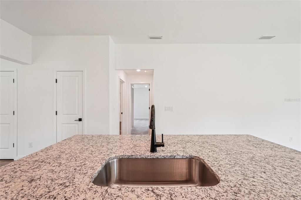 5237 Aberback Street North Port, FL 34291 - Photo 24 of 46 a kitchen with a sink and a mirror