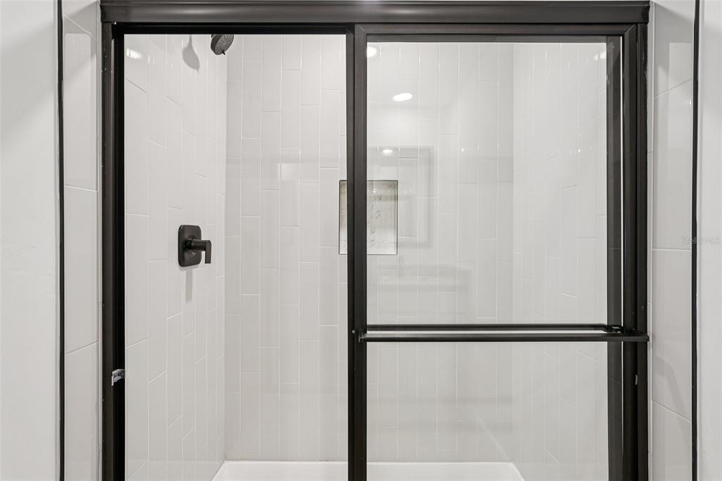 5237 Aberback Street North Port, FL 34291 - Photo 28 of 46 a bathroom with a glass shower door