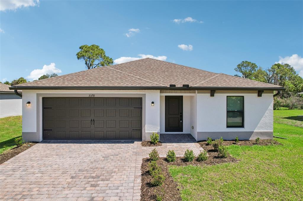 5237 Aberback Street North Port, FL 34291 - Photo 3 of 46 a front view of a house with a yard and garage
