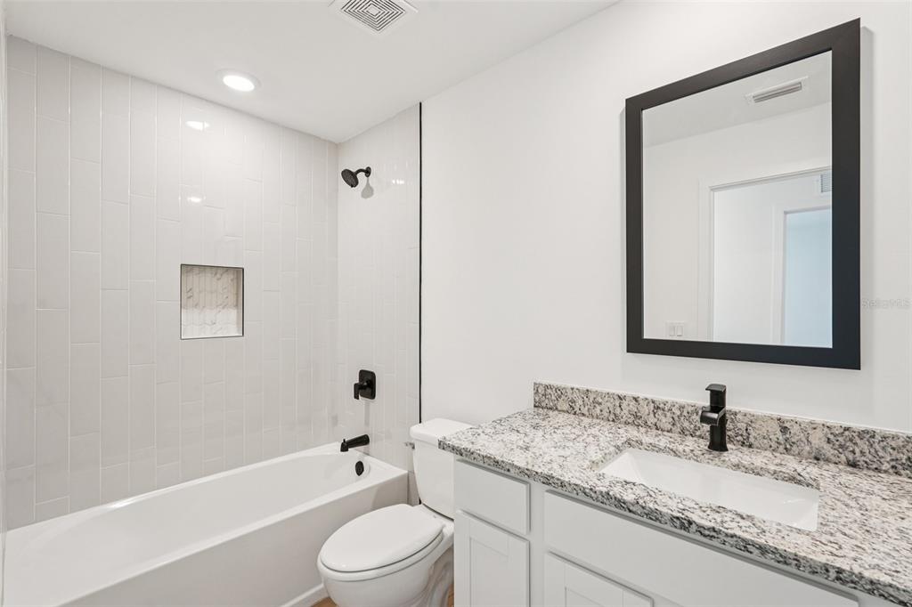 5237 Aberback Street North Port, FL 34291 - Photo 34 of 46 a bathroom with a granite countertop sink toilet and shower