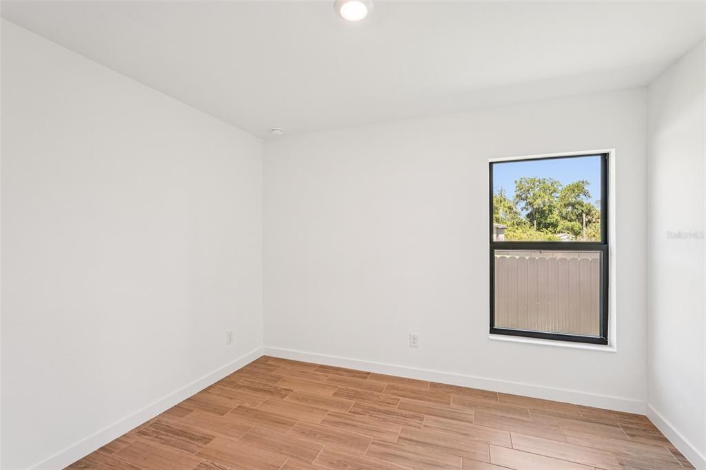 5237 Aberback Street North Port, FL 34291 - Photo 35 of 46 a view of an empty room with wooden floor and a window