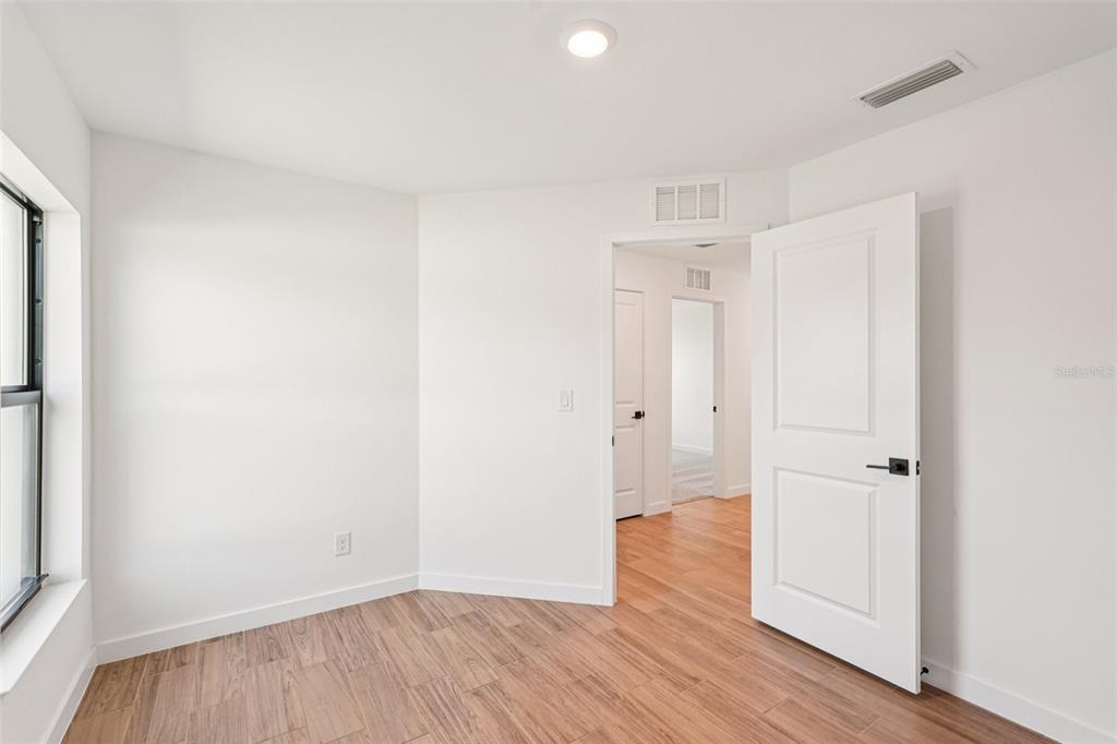 5237 Aberback Street North Port, FL 34291 - Photo 36 of 46 an empty room with wooden floor and a window