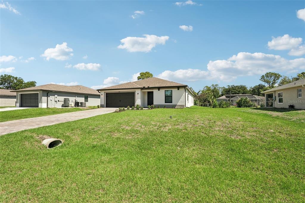 5237 Aberback Street North Port, FL 34291 - Photo 4 of 46 a front view of a house with garden