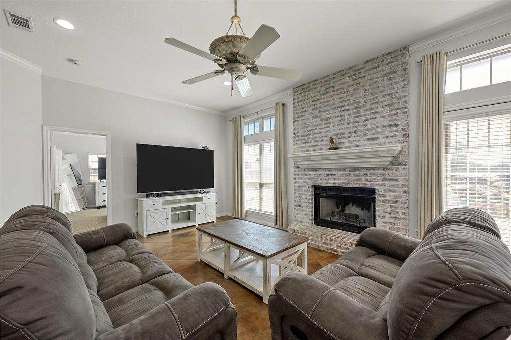 3696 Old Lorena Road Lorena, TX 76655 - Photo 5 of 27 Living room featuring a prominent brick fireplace with a white mantel, high ceilings with a ceiling fan, and recessed lighting
