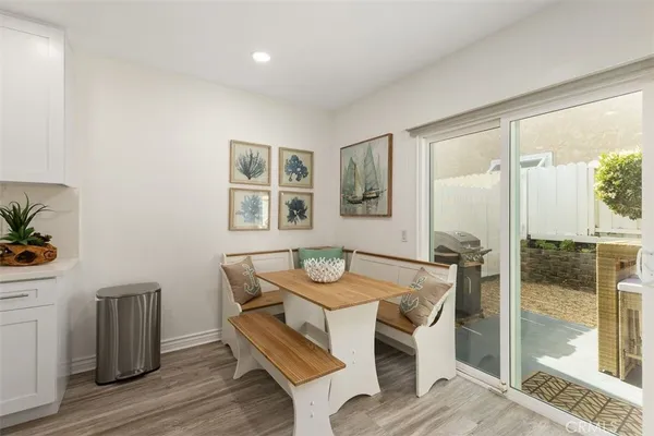 a dining room with wooden floor and glass door