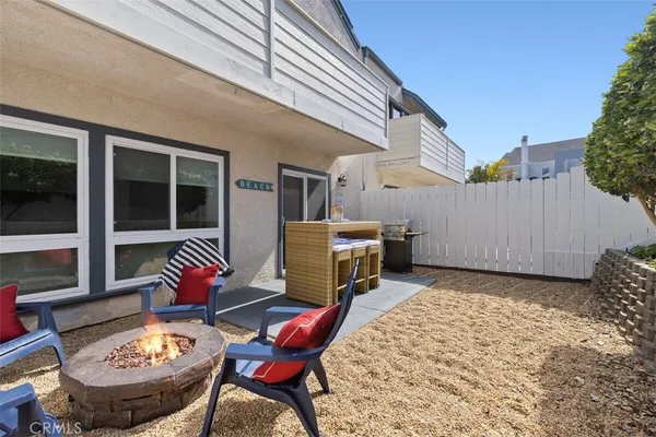 a backyard of a house with yard and outdoor seating