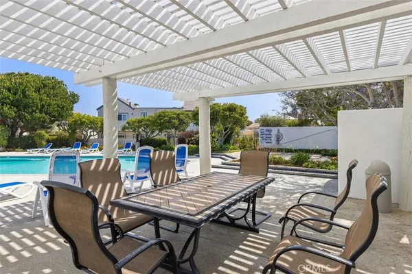 a view of a patio with couple of chairs and a table
