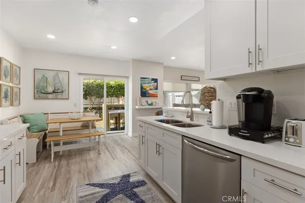 a kitchen with a sink appliances and cabinets