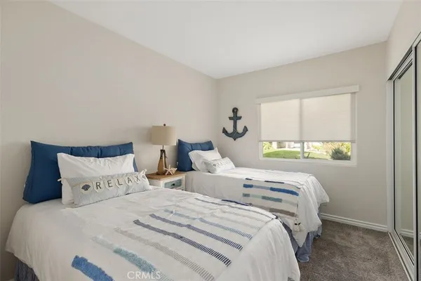 a bedroom with two beds and a window