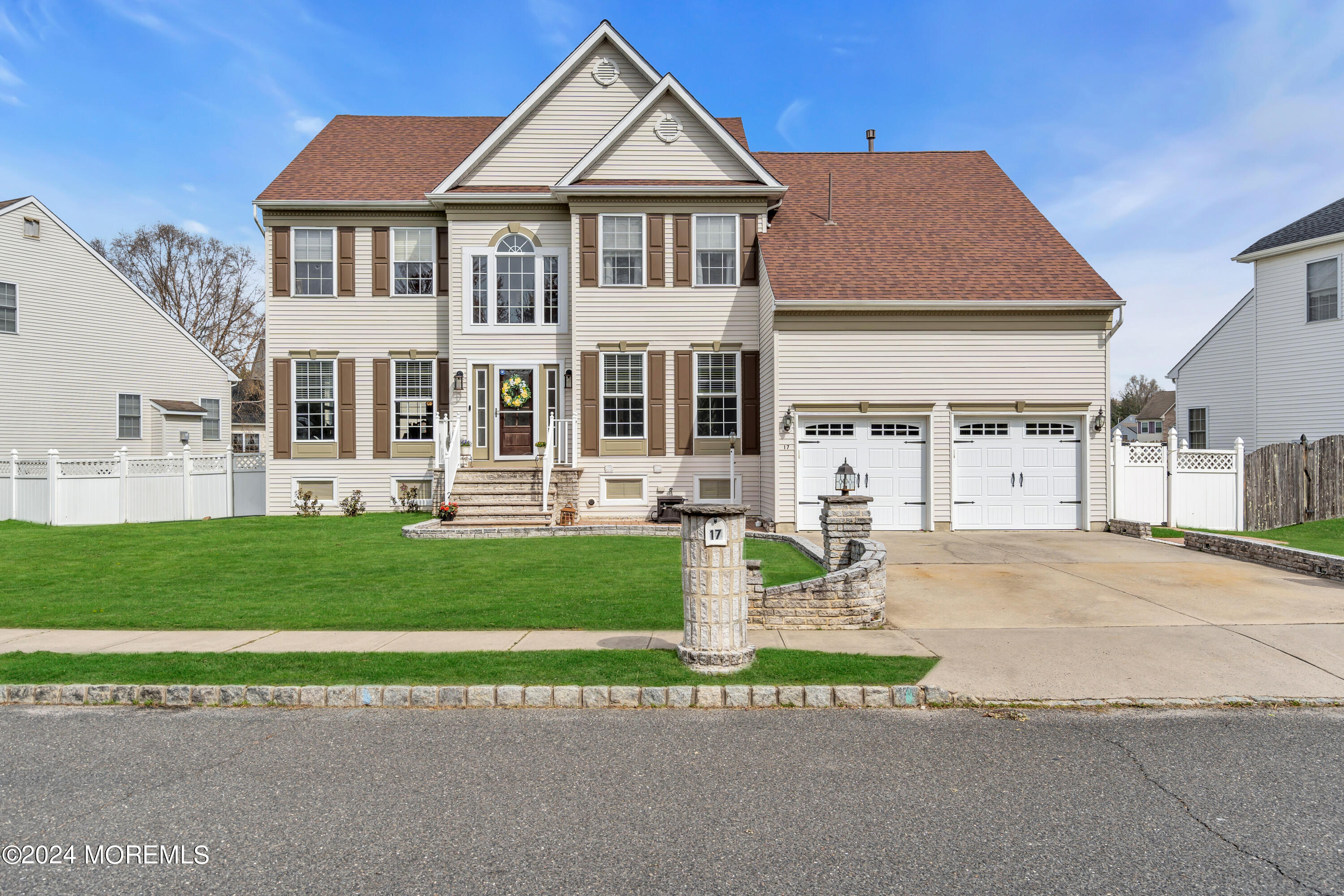 a front view of a house with a garden and plants