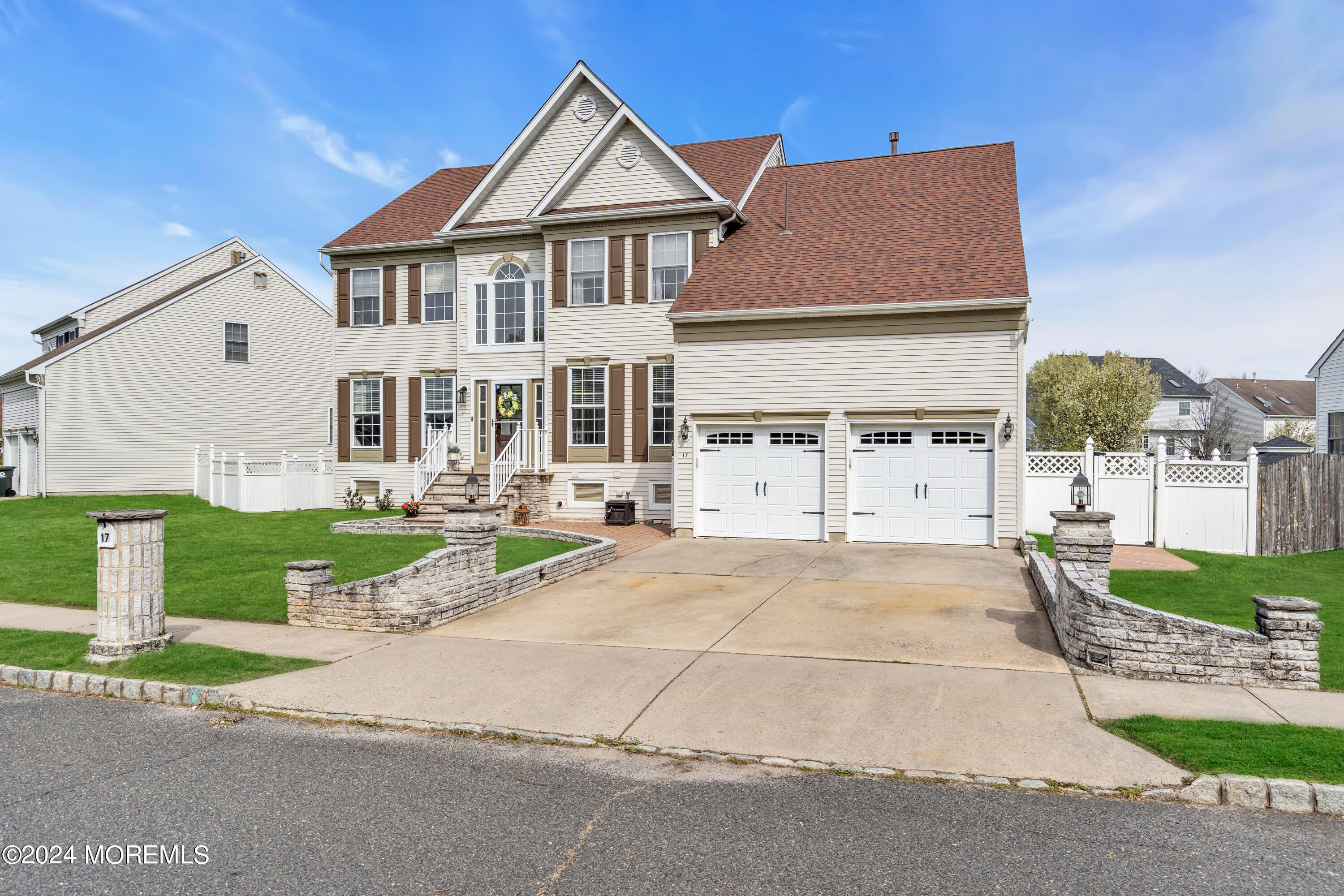 17 Gristmill Road Howell, NJ 07731 - Photo 15 of 71 a view of a white house with a yard and plants