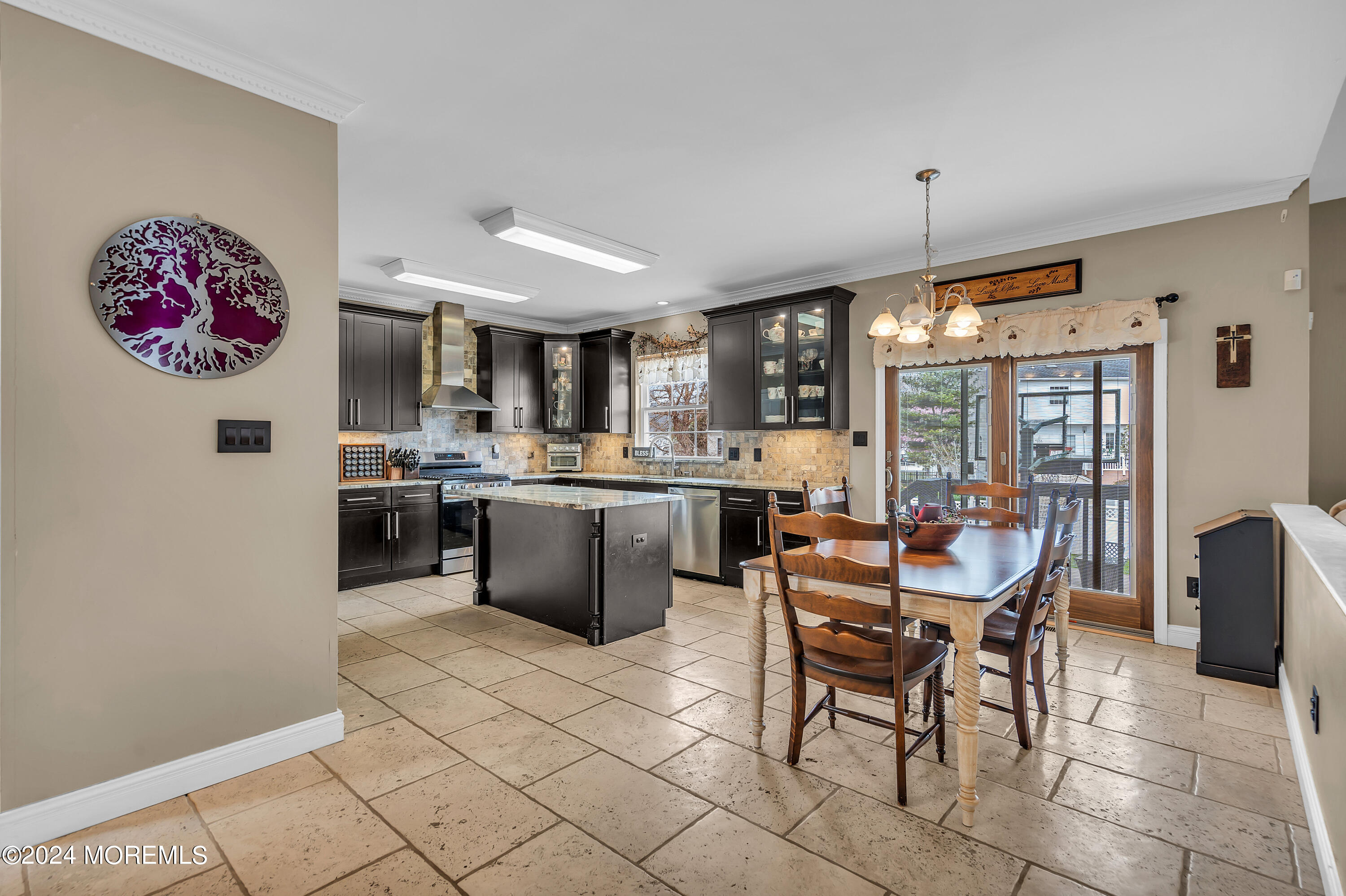 17 Gristmill Road Howell, NJ 07731 - Photo 24 of 71 a kitchen with a dining table chairs and white cabinets
