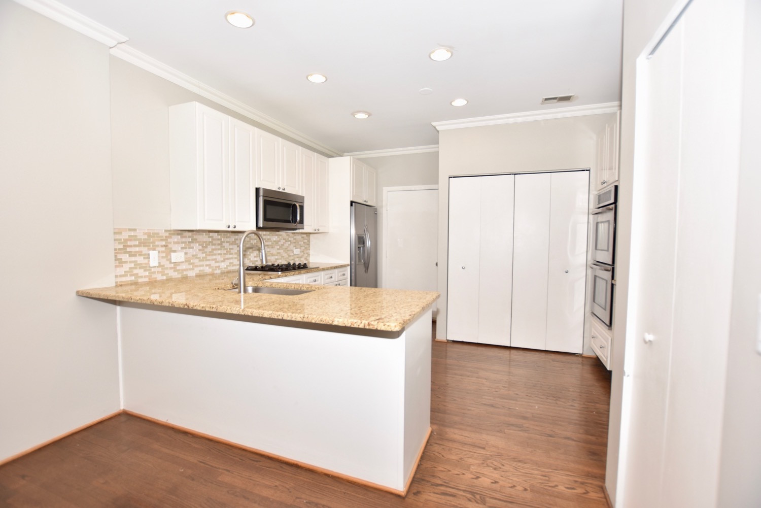 1801 West Diversey Parkway, Unit 18 Chicago, IL 60614 - Photo 7 of 32 a kitchen with stainless steel appliances granite countertop a sink and a refrigerator