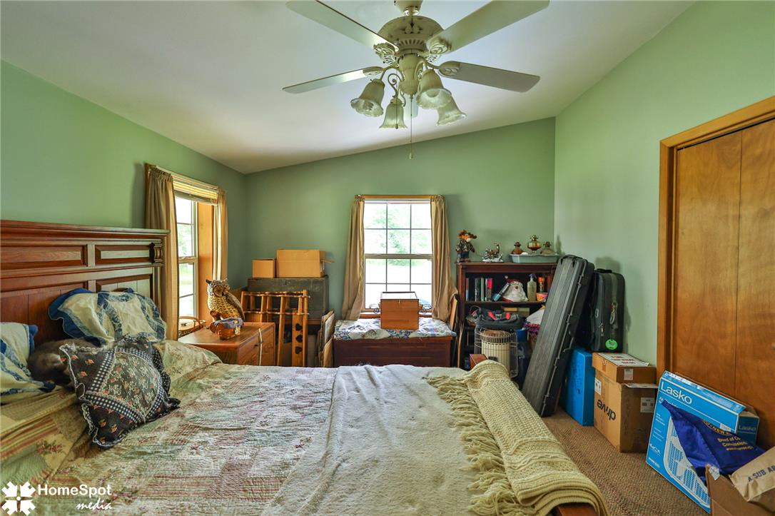 3795 Rhoades Road Kempton, PA 19529 - Photo 20 of 42 Sloped ceilings and a ceiling fan illuminate this functional bedroom space.