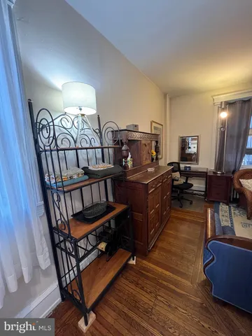 a kitchen with stainless steel appliances kitchen island granite countertop a table chairs sink and cabinets