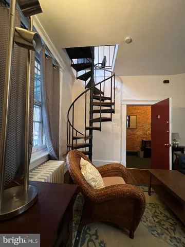 a bedroom with furniture and wooden floor
