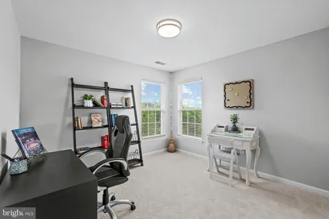 a spacious bedroom with a bed and a dresser