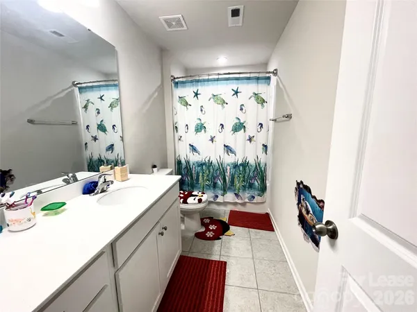 a bathroom with a sink mirror and shower