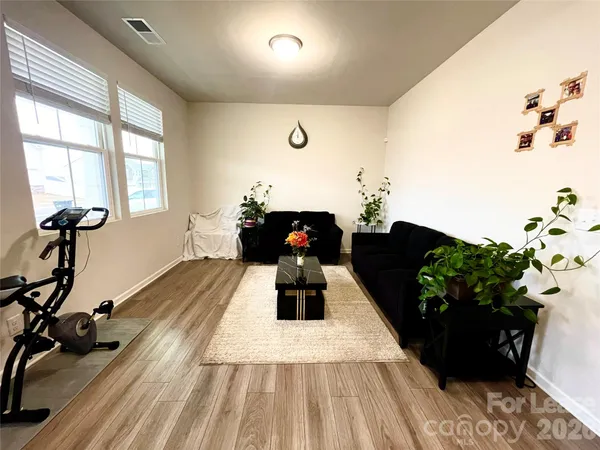 a living room with furniture fireplace and potted plant