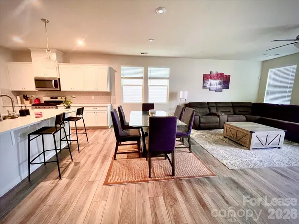 a view of a dining room with furniture window and wooden floor