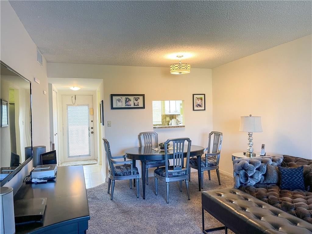 2781 North Pine Island Road, Unit 308 Sunrise, FL 33322 - Photo 12 of 16 a living room with furniture and a dining table with wooden floor