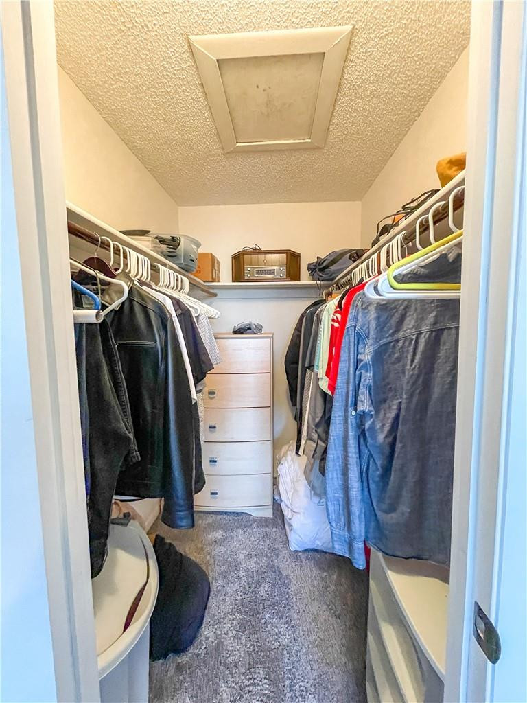 2781 North Pine Island Road, Unit 308 Sunrise, FL 33322 - Photo 14 of 16 a view of walk in closet with clothes and shoes